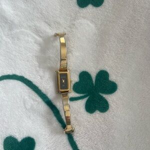 Woman bangle Gucci Gold and Black Watch with Rectangular Face.
